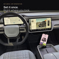 iPhone upright on the CNP Motive MagSafe mount in a Rivian R1 center console, beside the steering wheel and touchscreen