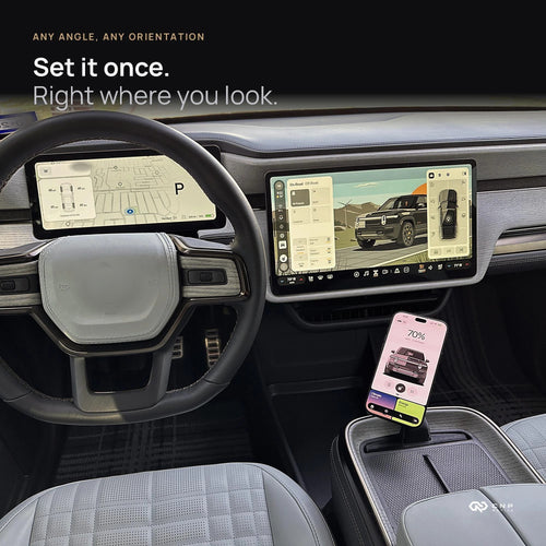 iPhone upright on the CNP Motive MagSafe mount in a Rivian R1 center console, beside the steering wheel and touchscreen